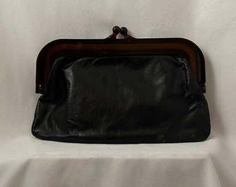 Vintage 60s black leather clutch with kiss-lock closure and transparent brown plastic frame