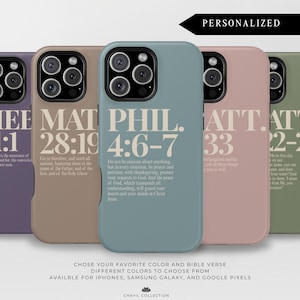 May include: A selection of phone cases in diverse colours, each featuring a different Bible verse. The cases are in shades of purple, tan, teal, pink, and green. Text on the cases includes "HEB 11:1", "MAT 28:19", "PHIL 4:6-7", "ATT 33", and "ATT 22-23".