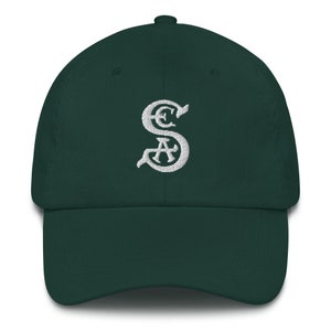 May include: A dark green baseball cap with a white embroidered "S" logo.