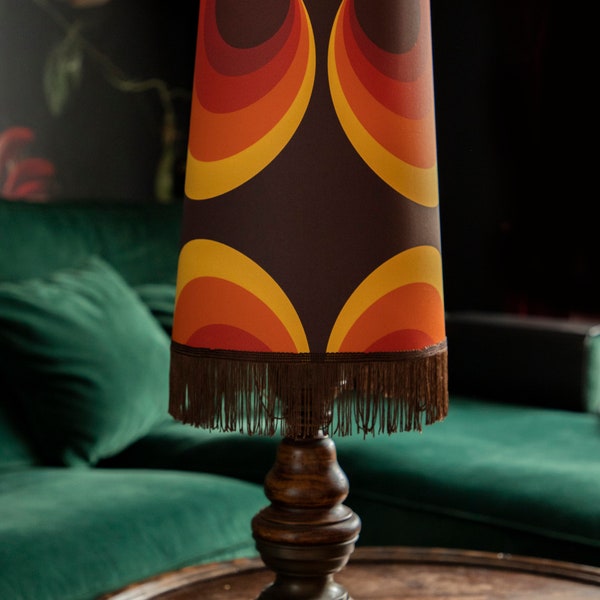 Homemade lampshade with fringe and geometric curves in different shades of orange-brown