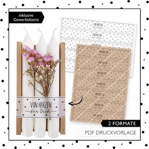 May include: Three white candles with a floral arrangement in a wooden box. The candles have labels that say "Von Herzen f&uuml;r Dich" which translates to "From the heart for you". The image also shows two printable label designs for candles.