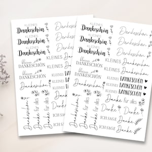 May include: A sheet of stickers with various thank you messages in German. The stickers feature small floral designs and the phrases "kleines Dankesch&ouml;n", "Danke", "Danke f&uuml;r alles", and "Ich sage Danke".