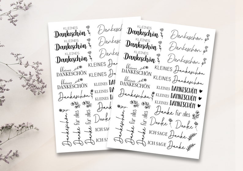 May include: A sheet of stickers with various thank you messages in German. The stickers feature small floral designs and the phrases "kleines Dankesch&ouml;n", "Danke", "Danke f&uuml;r alles", and "Ich sage Danke".