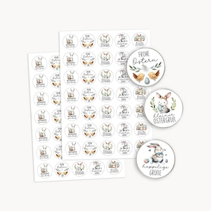 May include: A collection of round Easter stickers with German text and illustrations. The stickers feature bunnies, chicks, and eggs, with phrases like "Frohe Ostern" and "kleiner Ostergruß". The stickers are white with colorful designs.