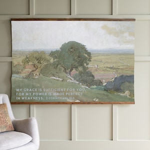 May include: A watercolor painting of a landscape with rolling hills, trees, and a winding road. The painting has a quote from the Bible, "My grace is sufficient for you, for my power is made perfect in weakness. 2 Corinthians 12:9."