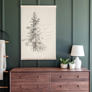 May include: A beige canvas print with a black and white drawing of a pine tree. The print has the text "Glory to God in the highest, and on earth peace, goodwill toward men! Luke 2:14".