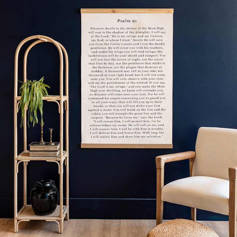 May include: A framed print of Psalm 91, a passage from the Bible, with a wooden frame and a white background. The text is in black font and reads, "Whoever dwells in the shelter of the Most High..."