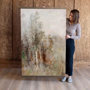 May include: A watercolor painting of a forest scene with tall trees and a misty background. The painting is framed in a simple wooden frame.