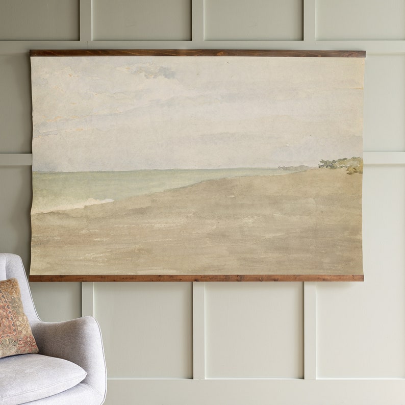 May include: A watercolour painting of a seascape with a light blue sky, a green ocean, and a brown sandy beach. The painting is framed in a dark brown wood frame.