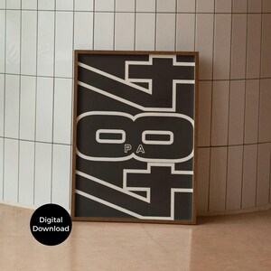 May include: A framed black and white art print featuring the number "84" in a bold, stylized font. The print includes the letters "PA" within the number. The frame is a dark brown color. The words "Digital Download" are in a black circle in the lower left corner.