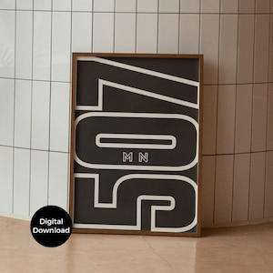 May include: A framed black and white art print featuring the number 507 in a bold, modern font. The letters "MN" are centered below the number. The frame is dark wood. A digital download is available.