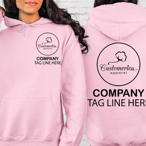 a woman wearing a pink sweatshirt with a company tag on it