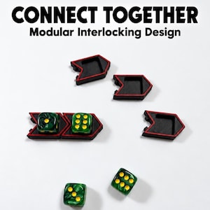 May include: Modular interlocking arrow-shaped trays in black with red trim, featuring the text CONNECT TOGETHER Modular Interlocking Design. Two green marbled dice with yellow pips are placed inside two trays, with two additional dice nearby.