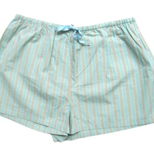 May include: Light blue striped pyjama shorts with a drawstring waist.
