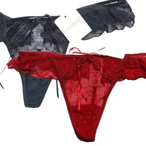 May include: Two pairs of lacy underwear, one black and one red. The red pair has a bow on the front and the black pair has a tag that says "ARIANNE".