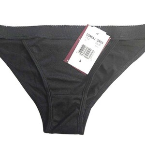 May include: Black lace underwear with a Donna L. Loren tag. The tag has the size "S" and a barcode.