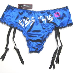 May include: Blue satin garter belt with black straps and a silver "Kiss This" graphic with a pink lipstick print.
