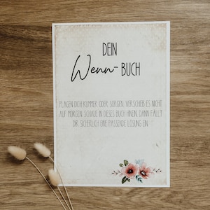 Könnte beinhalten: Ein druckbares Schild mit dem Text "DEIN Wenn-BUCH" und einem Zitat darüber, Lösungen in einem Buch zu finden. Das Schild hat eine Vintage-Ästhetik mit einem floralen Design in der rechten unteren Ecke.