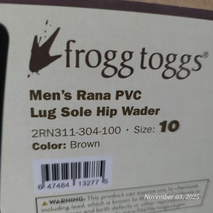 May include: A product label for Frogg Toggs Men's Rana PVC Lug Sole Hip Waders. The label is white with black text, including the brand logo, product details, size 10, and brown color. A barcode is also visible.