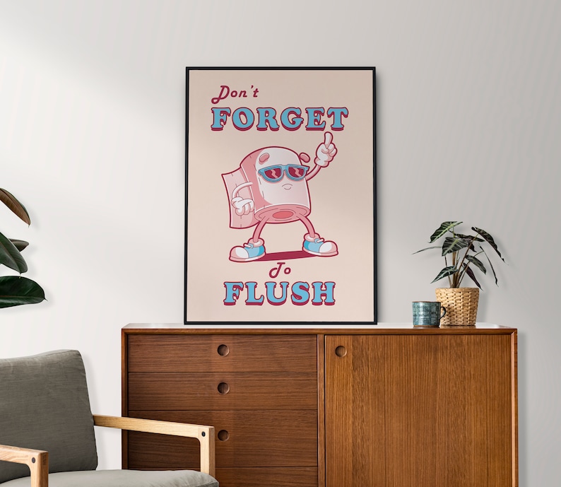 May include: A humorous poster with a cartoon toilet paper roll wearing sunglasses and saying "Don't forget to flush". The poster has a pink background with blue and red text.