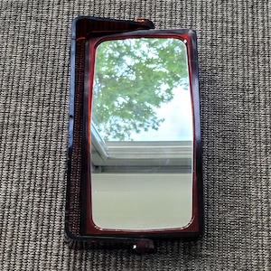 Vintage bathroom mirror with two magnifying mirrors.