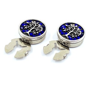 May include: Two silver-toned shirt cufflinks with a blue and silver tree design. Each cufflink has a round, decorative top and a silver-toned clip.