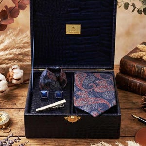 May include: A set of three ceramic mugs with a speckled, matte finish in cream, light grey, and dark grey. Each mug has a simple, minimalist design, suitable for coffee or tea.