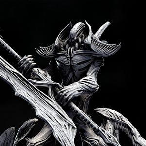 May include: Three gray Technocron II sculptures, a tribute to H.R. Giger, are displayed. The central figure holds a large, ornate blade. The sculptures are on round bases, showcasing intricate, biomechanical designs.