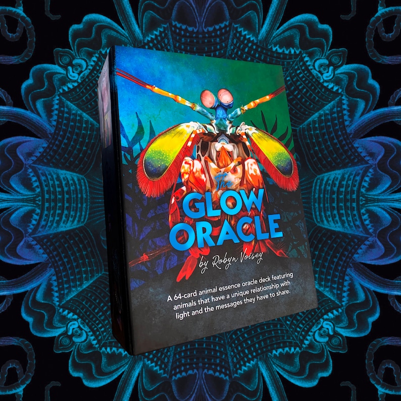 Peut inclure: Une bo&icirc;te noire avec une illustration color&eacute;e d'une crevette-mante sur le devant. La bo&icirc;te est intitul&eacute;e "Glow Oracle" par Robyn Voisey. Le texte sous le titre indique "Un jeu d'oracle d'essence animale de 64 cartes mettant en sc&egrave;ne des animaux qui ont une relation unique avec la lumi&egrave;re et les messages qu'ils ont &agrave; partager."