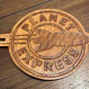 Stained basswood Planet Express logo magnet from Futurama with semi gloss finish
