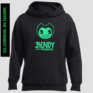 May include: Black hoodie featuring a green cartoon character and the text "Bendy and the Ink Machine" on the front.