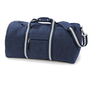 May include: A navy blue canvas duffel bag with white trim and a zippered pocket on the front.