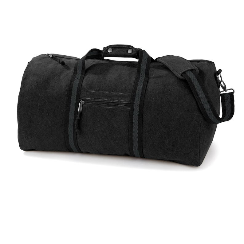 May include: A black canvas duffel bag with a zippered pocket and a top handle. The bag has a gray stripe along the sides and a gray strap.