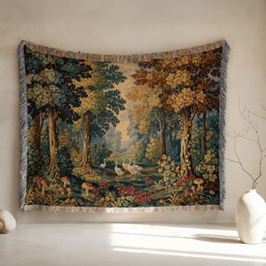 May include: A rectangular woven wall tapestry featuring a forest landscape with tall trees in shades of green and brown, a group of white geese in the center, and various mushrooms and colorful flowers scattered across the forest floor.