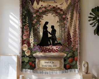 Può includere: Una coperta tessuta che presenta una scena romantica con la silhouette di una persona inginocchiata davanti a un'altra sotto un arco coperto di rose. Il design include bordi floreali, fragole e un piedistallo in pietra con il testo Sarah & Joe October 15th, 2025.