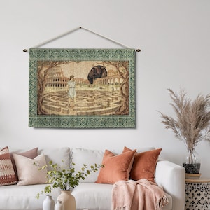 May include: A tapestry wall hanging depicting a scene from Greek mythology. The artwork features a maze, a figure, and a bull. The tapestry has a green border and is hung from a wooden rod with a beige cord.