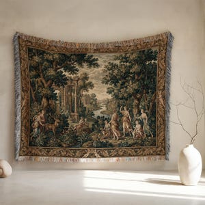 May include: A rectangular woven wall tapestry featuring a detailed pastoral landscape scene with classical figures, a stag, and ancient stone ruins. The border displays intricate foliage and cherub motifs, finished with a fringed edge.