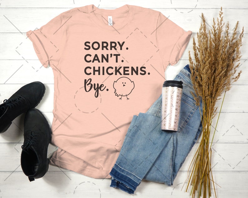 May include: A peach-coloured t-shirt with the text "SORRY. CAN'T. CHICKENS. Bye." and a small black and white cartoon chicken illustration.