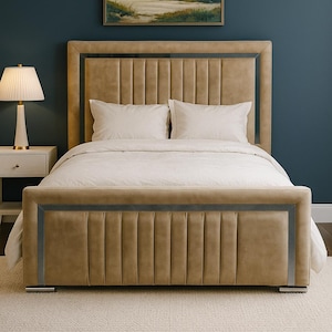 May include: A contemporary bed with a tan upholstered headboard and frame, featuring silver trim. The bed is made up with white bedding and pillows. A painting of a beach scene hangs above the bed.