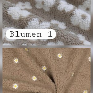 May include: Close-up of two sections of plush fabric. The top section is a light brown colour with white daisy-like flower patterns. The bottom section is a darker brown with small white and yellow flower patterns. The text "Blumen 1" and "Blumen 2" are visible.