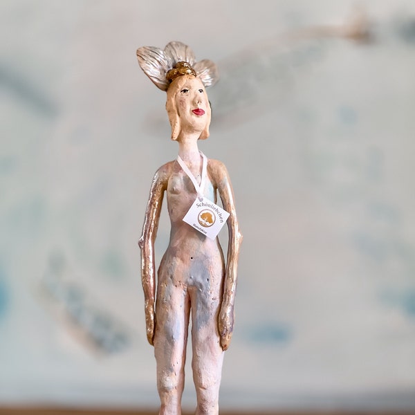 Standing sculpture with headdress and gold accents, pastel colored ceramic sculpture, contemporary ceramic sculpture woman