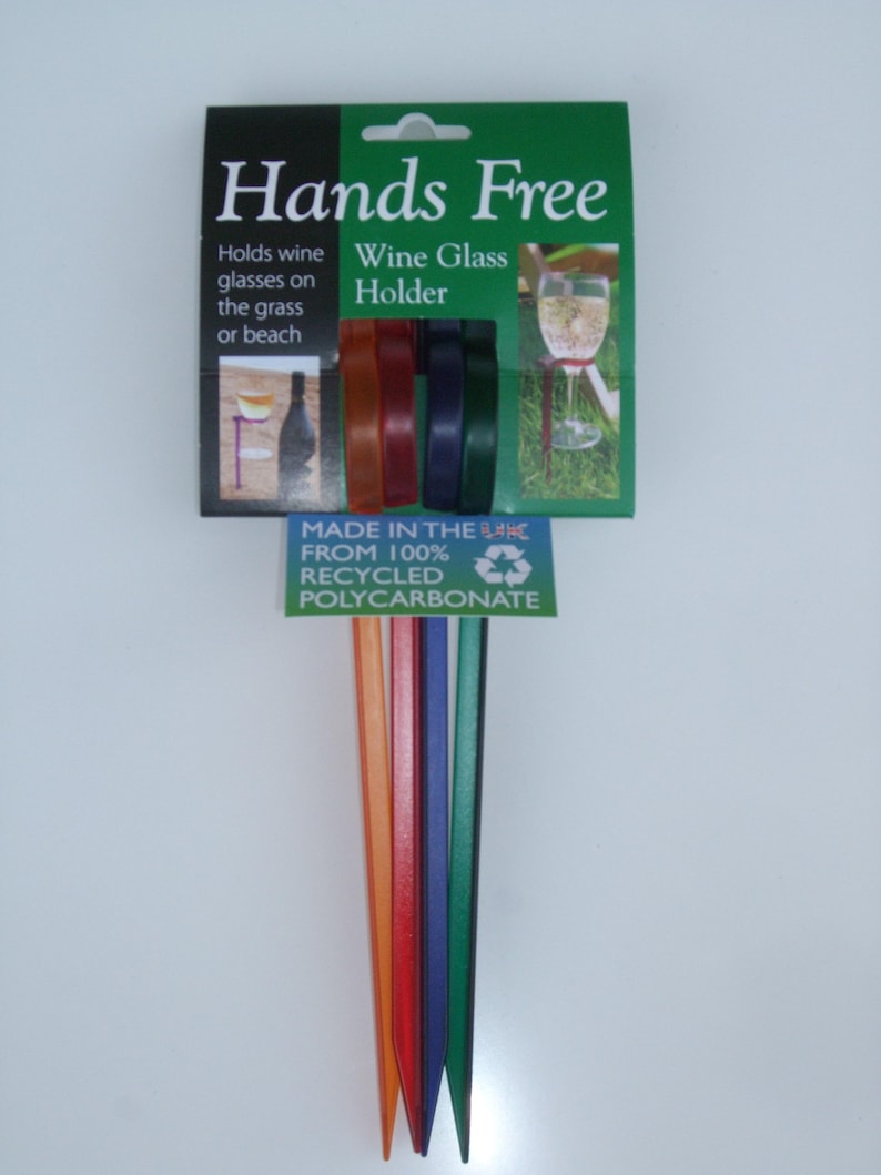 May include: Set of six colorful plastic wine glass holders. The holders are made from 100% recycled polycarbonate and are designed to hold wine glasses securely in the ground. The packaging says "Hands Free Wine Glass Holder".