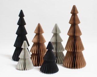 May include: Five paper Christmas trees in different sizes and colors. The trees are made of folded paper and have a honeycomb texture. The colors are black, brown, and gray.