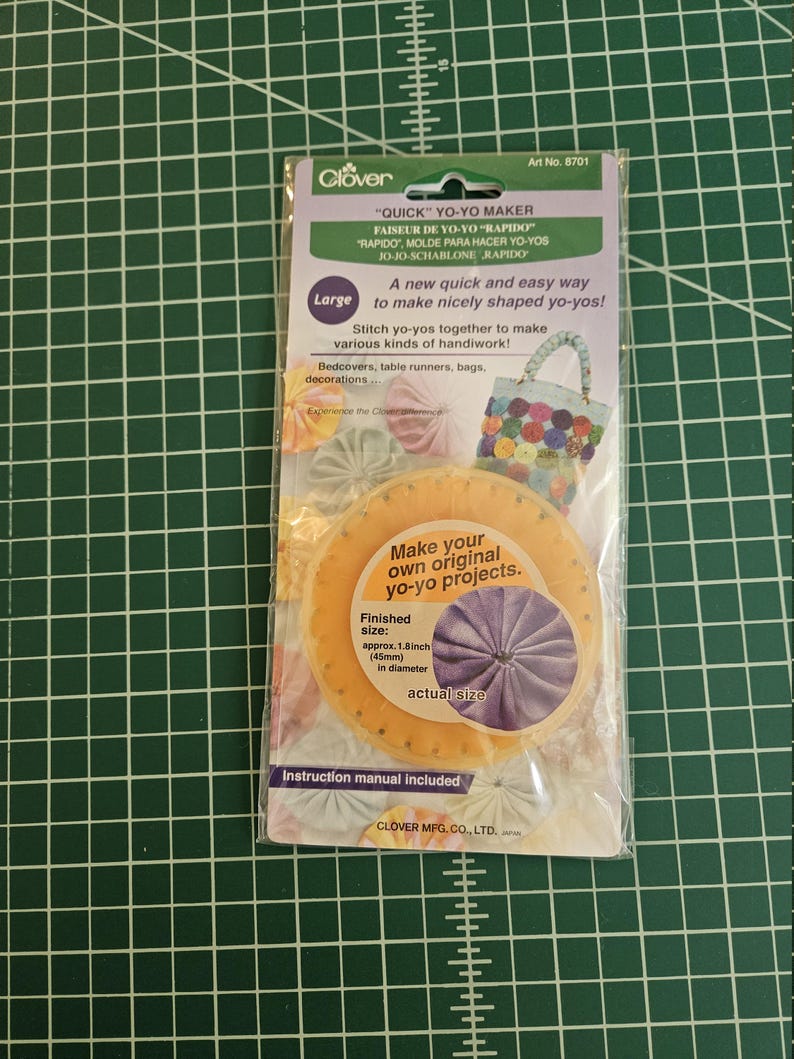 May include: A Clover brand large Quick Yo-Yo Maker in its original plastic packaging. The packaging features the text "QUICK YO-YO MAKER," "Large," and "Make your own original yo-yo projects." It indicates a finished size of 45mm in diameter.