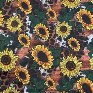 May include: A brown and tan fabric with a repeating pattern of sunflowers and cactus plants. The sunflowers are yellow with brown centers and the cactus plants are green with brown spines.