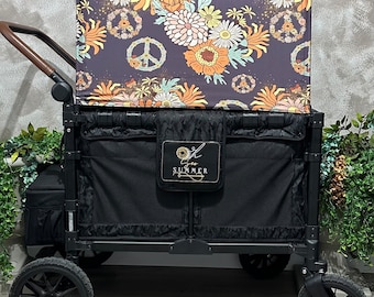 May include: A black wagon with a floral patterned canopy featuring peace signs. The canopy is labeled "For the Summer".