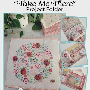 May include: A project folder with the text "Take Me There" and floral embroidery. The folder includes a variety of templates and pre-printed linen. The design features a floral pattern with red, pink, and blue accents.