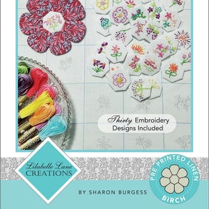 May include: A pre-printed linen embroidery kit titled "Field of Blooms." The kit includes thirty embroidery designs. The image shows a flower-shaped design, individual floral designs, and colorful embroidery floss. The text "Thirty Embroidery Designs Included" is visible.