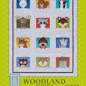 May include: A white quilt with a woodland animal design. The quilt features squares with appliqued animals like a bunny, bear, skunk, moose, raccoon, fox, squirrel, bear, mouse, owl, deer, and hedgehog. The quilt is bordered by a brown and white dotted pattern.