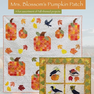 May include: A quilt featuring a pumpkin patch theme with pumpkins, leaves, and a crow. The quilt has a white background with orange, yellow, and brown pumpkins. The text "Mrs. Blossom's Pumpkin Patch" and "A fun assortment of Fall-themed projects" are visible.